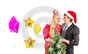 Young happiness couple enjoy posing with colorful balloons and christmas tree in new year celebration party