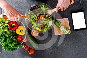 Young happiness Woman Cooking vegetables salad in the kitchen, H