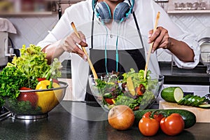 Young happiness Woman Cooking vegetables salad in the kitchen, H