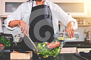 Young happiness Woman Cooking vegetables salad in the kitchen, H