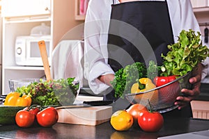 Young happiness Woman Cooking vegetables salad in the kitchen, H