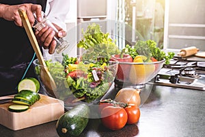 Young happiness Woman Cooking vegetables salad in the kitchen, H