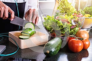 Young happiness Woman Cooking vegetables salad in the kitchen, H