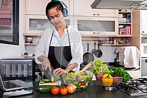 Young happiness Woman Cooking vegetables salad in the kitchen, H