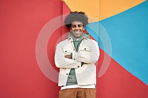 Young happy African American teen guy isolated at colorful wall background.