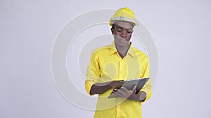 Young happy African businessman as engineer directing while holding clipboard