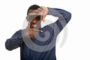 Young happy African man smiling and focusing with fingers