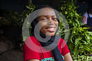 young happy african woman selling in a local market laughing