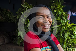 young happy african woman selling in a local market laughing