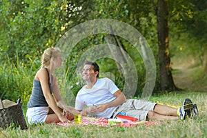 young happy amorous couple on picnic outdoors