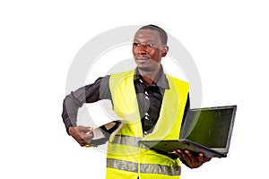 Young happy architect man holding laptop computer and safety hel