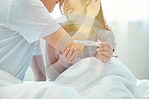 Young happy asian couple with encourage and hug together with pregnancy test.Expecting mom with cheerful face with pregnancy in