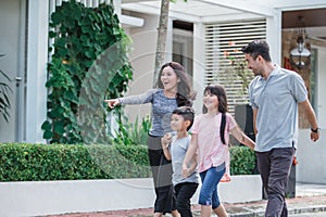 Young happy asian family walking together