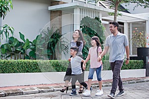 Young happy asian family walking together