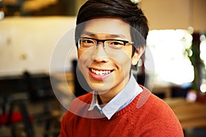 Young happy asian man with glasses