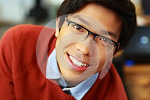 Young happy asian man with glasses