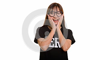 Young happy Asian nerd teenage girl smiling and looking surprise