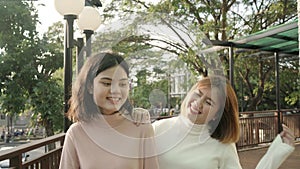 Young happy asian pretty girls couple friend travel walk in the city street relax talk with smile face. Close Up portrait joyful
