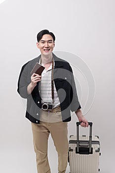 Young happy asian tourist man over white background studio, travel and holidays concept