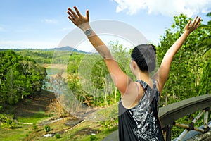 Young happy Asian woman enjoying holiday trip in Indonesia - Korean girl spreading arms free and excited from jungle viewpoint