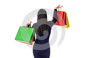 Young happy Asian woman holding shopping bags with smiley face isolated on white