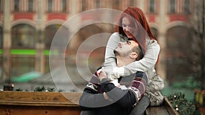 Young Happy Attractive Amorous Couple Embracing And Kissing Outdoor. Merry Christmas and New Year Concept. Good Mood and