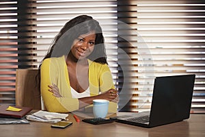 Young happy and attractive black African American business woman smiling cheerful and confident working at office computer desk