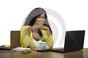 Young happy and attractive black Afro American business woman smiling cheerful and confident working at office computer desk relax