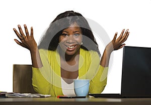 Young happy and attractive black Afro American business woman smiling cheerful and confident working at office computer desk relax