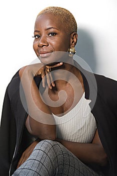 Young happy and attractive black afro American woman with modern hair style posing cheerful and cool smiling on isolated backgroun