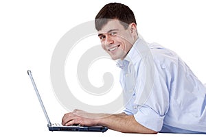 Young, happy, attractive man with computer