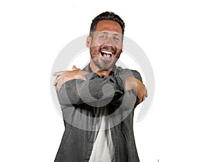 Young happy and attractive man hugging himself smiling positive and charming doing hug gesture in self esteem and self confidence