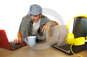 Young happy and attractive millennial business man working with laptop computer as internet blogger and technology geek in online