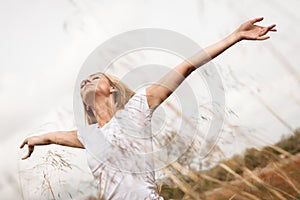 Young happy attractive woman arms wide open