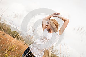 Young happy attractive woman arms wide open