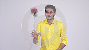 Young happy bearded Indian businessman ready for Valentine`s day