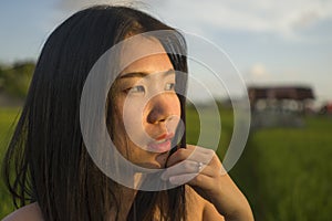 Young happy and beautiful Asian woman enjoying nature at rice field. sweet Chinese girl exploring countryside during holiday