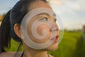 Young happy and beautiful Asian woman enjoying nature at rice field. sweet Chinese girl exploring countryside during holiday