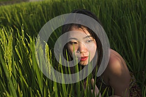 Young happy and beautiful Asian woman enjoying nature at rice field. sweet Chinese girl exploring countryside during holiday