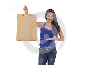 Young happy and beautiful hispanic woman holding brown shopping bag smiling excited isolated on white