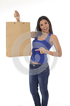 Young happy and beautiful hispanic woman holding brown shopping bag smiling excited isolated on white