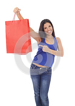 Young happy and beautiful hispanic woman holding red shopping bag smiling excited isolated on white