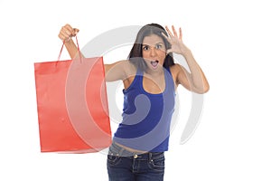 Young happy and beautiful hispanic woman holding red shopping bag smiling excited isolated on white