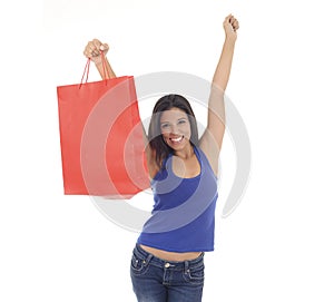 Young happy and beautiful hispanic woman holding red shopping bag smiling excited isolated on white