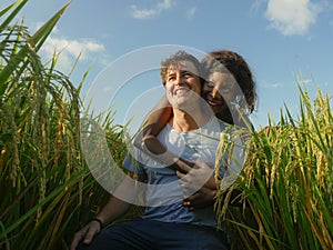 Young happy and beautiful mixed ethnicity couple with black African American woman and attractive Caucasian man cuddling and