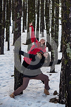 Young happy and beautiful teenage  standing and chatting at snow in winter