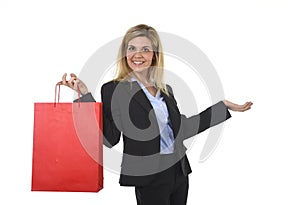 Young happy beautiful woman in business suit in excited face expression holding red shopping bag