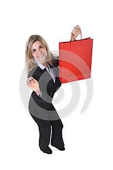 Young happy beautiful woman in business suit in excited face expression holding red shopping bag