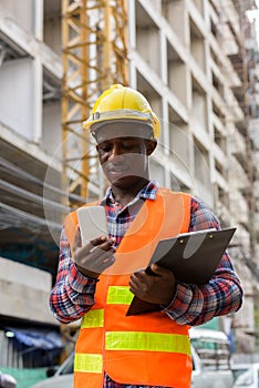 Young happy black African man construction worker smiling while
