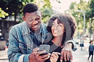 Young happy black couple outdoors